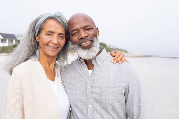 istock Couple smiling at the beach 1161145396