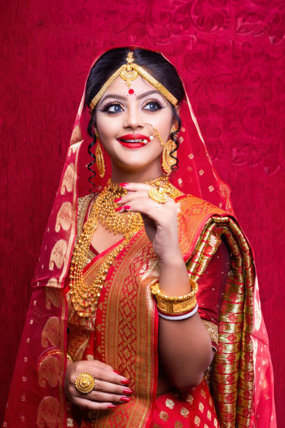 istock Beautiful smiling Indian bride posing in sari with jewelry 1161146885
