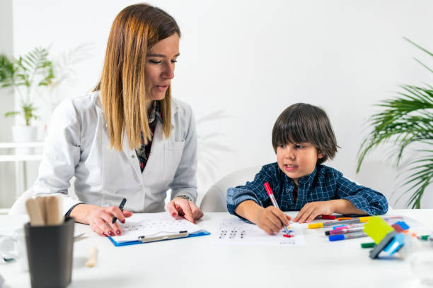 istock Teacher And Student Drawing On Table In Classroom 1161147344