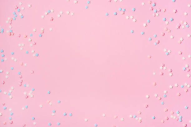 istock Little stars confetti on pink background 1161147855