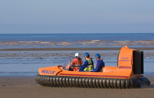 Rescue hovercraft driving along the beach.