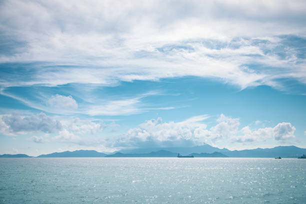 istock Cargo ship on horizon, clear sky, wide shot 1161148396