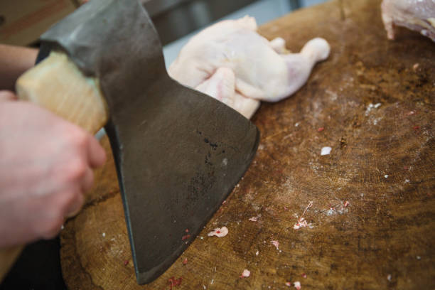 The process of cutting and chopping meat.