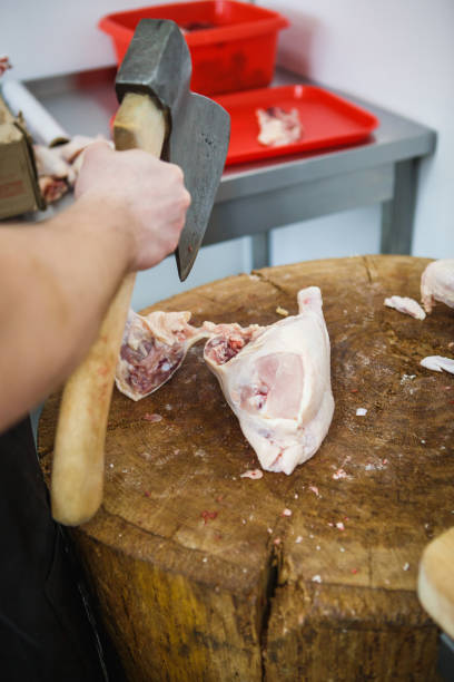 The process of cutting and chopping meat.