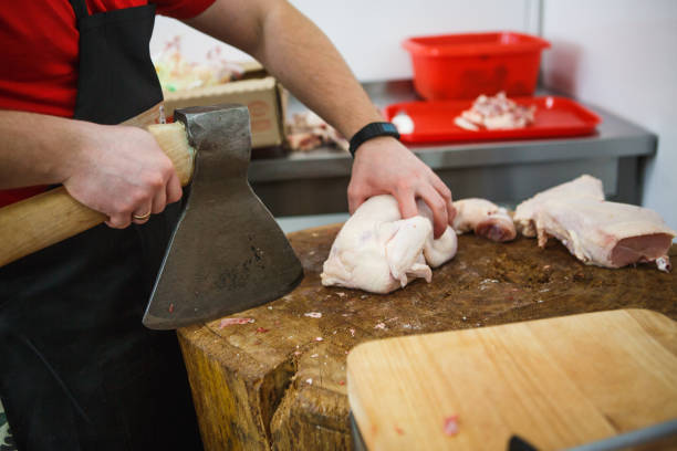 The process of cutting and chopping meat.