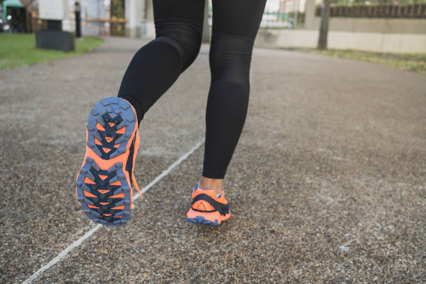 istock Low Section Of Woman Running On Road 1161149415