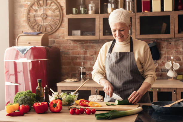 istock Happy senior woman cooking in her kitchen 1161150187