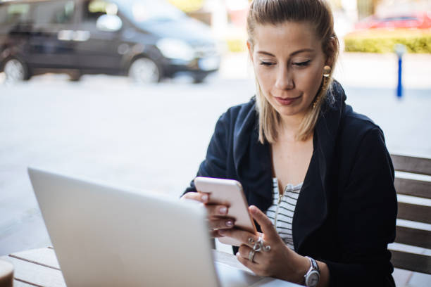 istock Woman using smartphone and laptop 1161151301