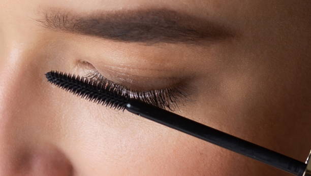 istock Girl Applying Black Mascara on her Eyelashes 1161151331