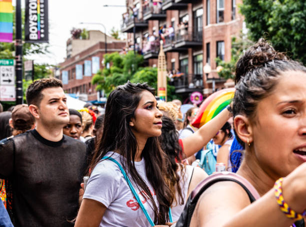 A woman observes the excitement at the Gay Pride parade. stock photo