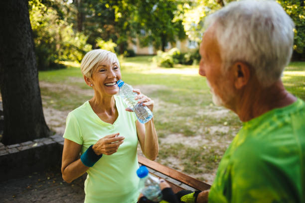 istock Senior couple staying hydrated after running, jogging 1161151760