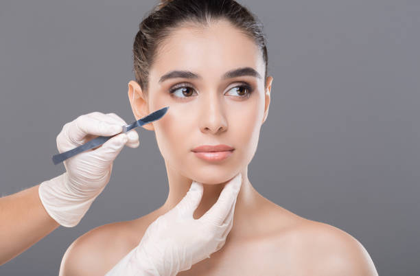 istock Cosmetologist preparing young woman for plastic surgery procedure 1161151850