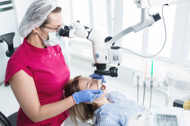 istock A female professional dentist examines a female patient with a stamotologic microscope in her office 1161153158