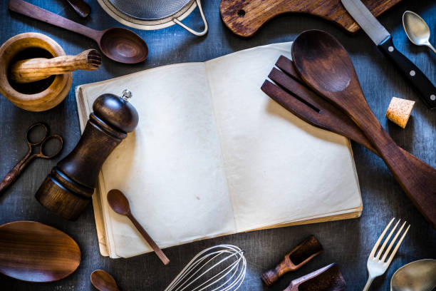 istock Vintage cookbook with kitchen utensils 1161153251