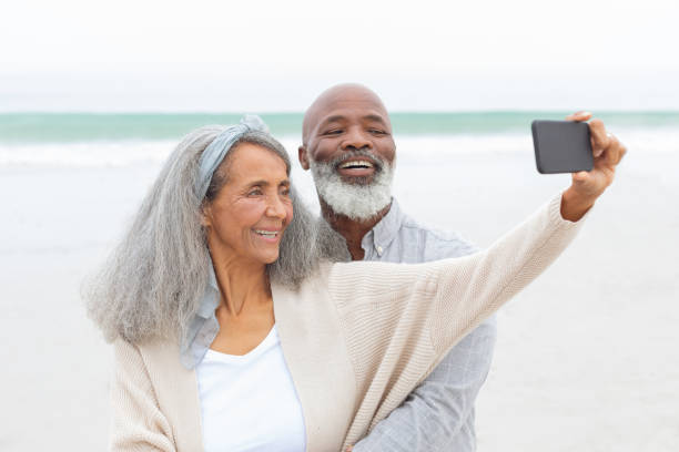 istock Couple taking a picture with smartphone at the beach 1161153449
