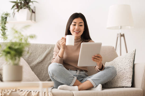 istock Online Education Concept. Girl Using Tablet and Drinking Tea 1161153523