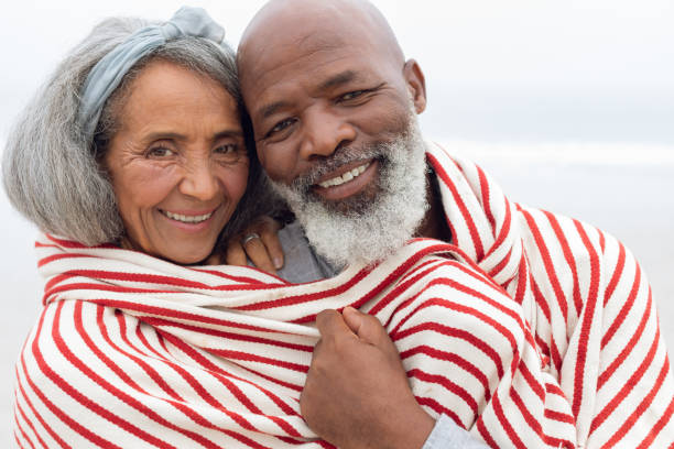 istock Couple smiling at the beach 1161153554