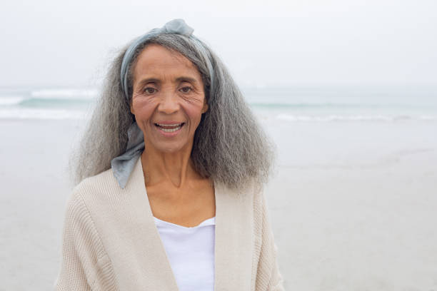 istock Woman smiling at the beach 1161154418