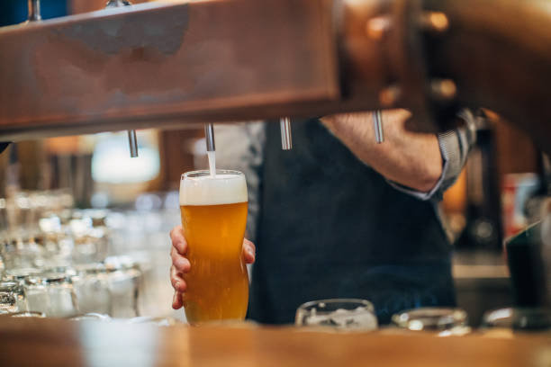 istock Barman pouring beer from beer tap 1161154451