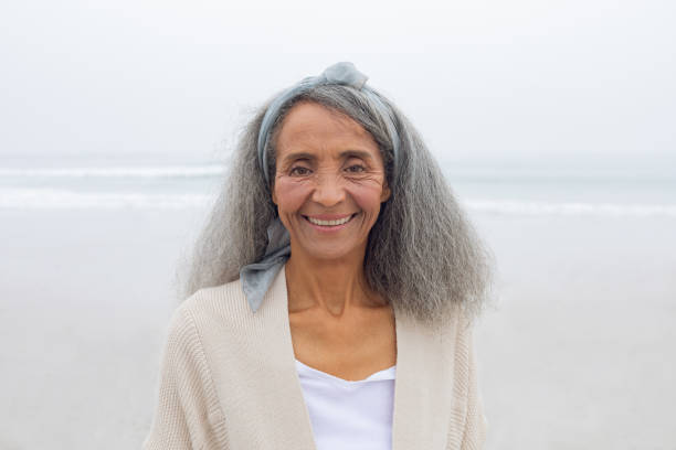 istock Woman smiling at the beach 1161154463
