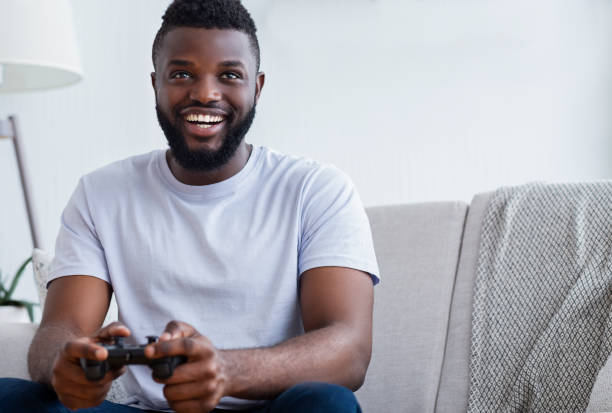 istock Young man playing video games at home 1161154854