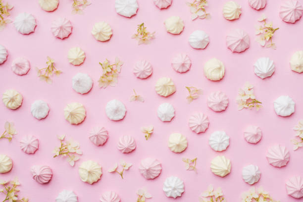 istock Colored small meringues on a pink background. Flat lay concept. Copy space. 1161157535