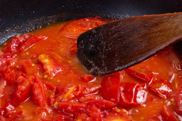 istock tomato frying on pan, cooking vegetable sauce,  background. 1161157730