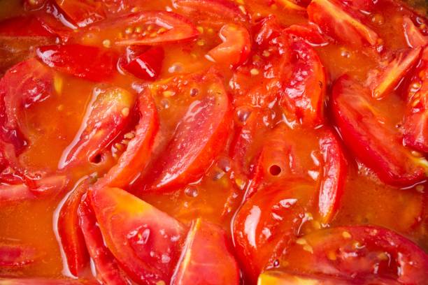 istock tomato frying on pan, cooking vegetable sauce,  red. 1161157736
