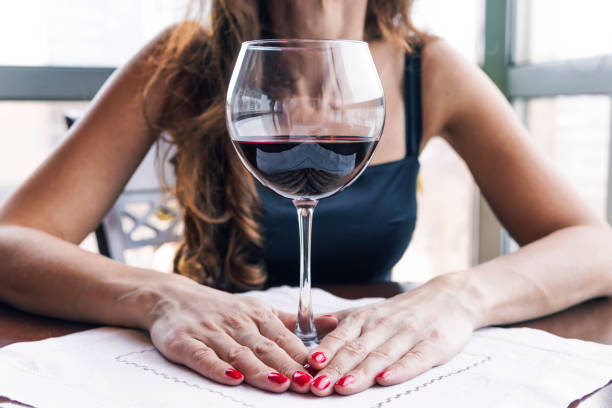 https://media.istockphoto.com/id/1161159150/photo/drunk-woman-sitting-at-a-table-and-holding-a-glass-of-wine-close-up-female-alcoholism.jpg?s=612x612&w=0&k=20&c=qV5nuUIZu3WwpSHDdl34Y6c8HXCT0R6Z_BL5pq2HjBw=