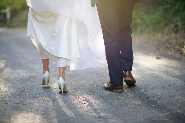 istock Bride and Groom Feet walking together rear view 1161160715
