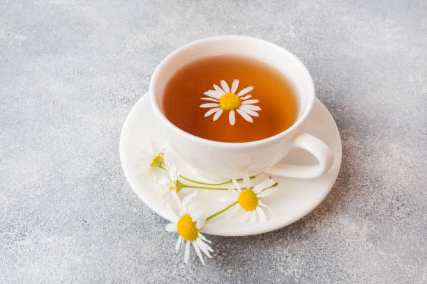 istock cup of herbal tea with chamomile flowers on grey table. Copy space 1161161799