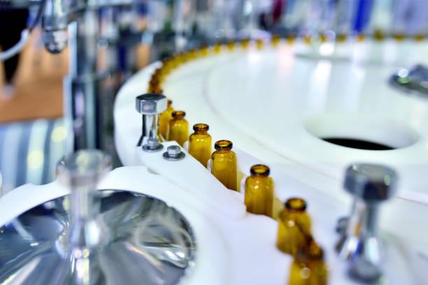 Close-up of Brown Glass Bottle at Turntable Production Line Close-up of brown glass bottle at turntable production line. pharmaceutical factory photos stock pictures, royalty-free photos & images