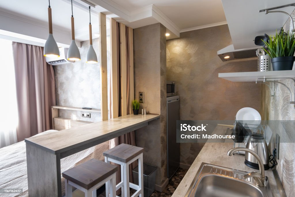 View of the kitchen and bar in a small hotel room - studio Small Stock Photo