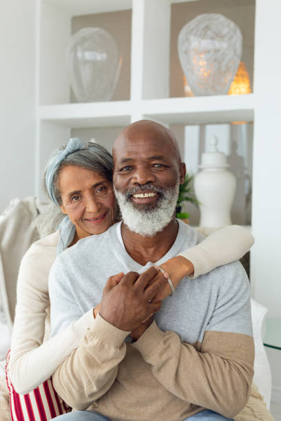 istock Couple sitting inside a room smiling. 1161163086