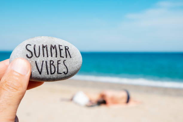 istock text summer vibes in a stone on the beach 1161163409