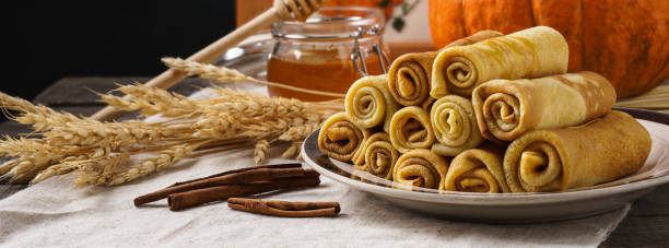 istock Pumpkin crepes with honey and cinnamon on a table. 1161163894