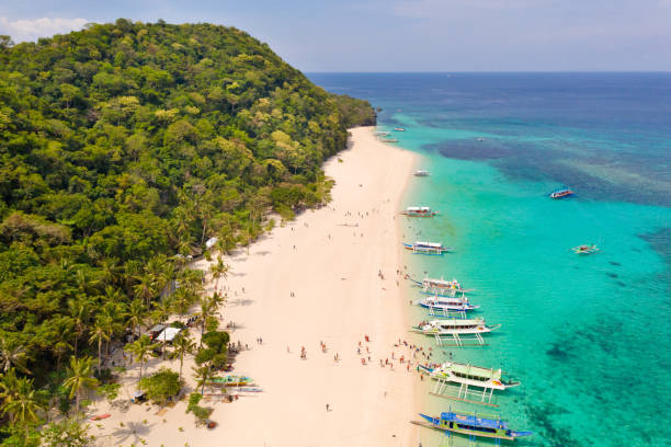 istock Puka Shell Beach. Wide tropical beach with white sand. Beautiful white beach and azure water on Boracay island, Philippines, top view 1161165037