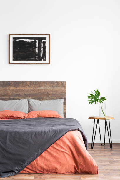 istock White minimal interior with simple bed, coral and grey linen bedsheets and nightstand 1161166280