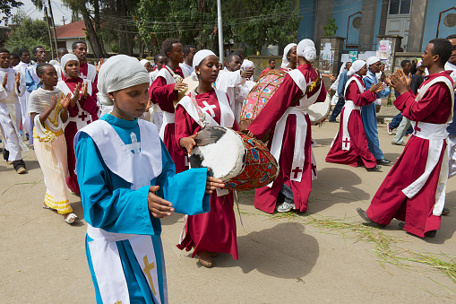 Addis Ababa, Ethiopia - January 19, 2010: Ethiopian people wearing traditional dresses take part in procession celebrating Timkat religious Orthodox festival at the street in Addis Ababa, Ethiopia.