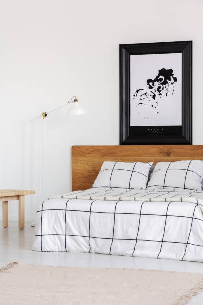 istock Black and white map in black frame in trendy bedroom interior with chequered bedroom 1161167946