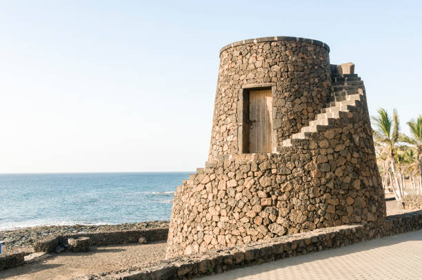 Round tower defence by the sea in a Spanish town