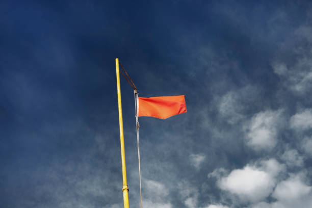 istock Red flag against the blue sky 1161170978