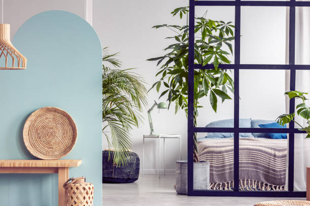 istock Urban jungle in bright white and blue bedroom interior with partition 1161171015