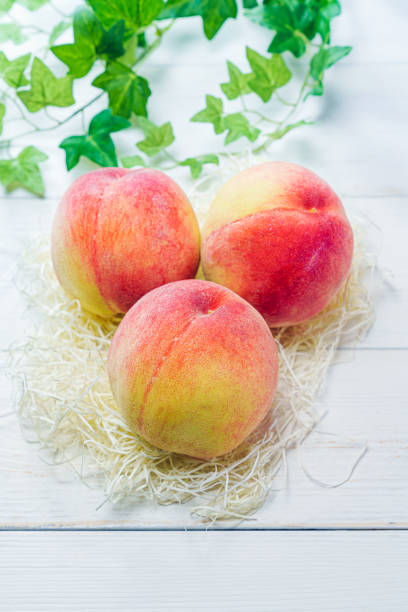 Fresh peaches on wooden background