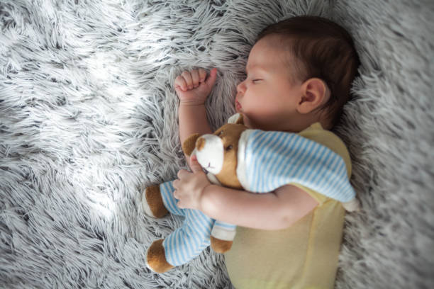 istock Baby boy sleeping with teddy bear 1161171625