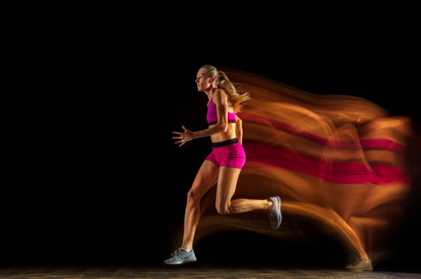 istock Professional female relay racer training on black studio background in mixed light 1161173072