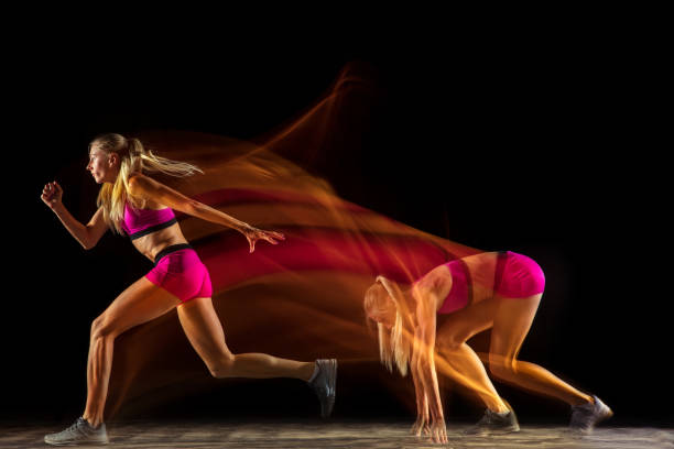 istock Professional female relay racer training on black studio background in mixed light 1161173081