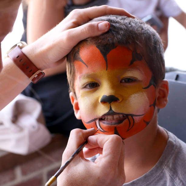 istock Make up artist painting a child's face 1161174145