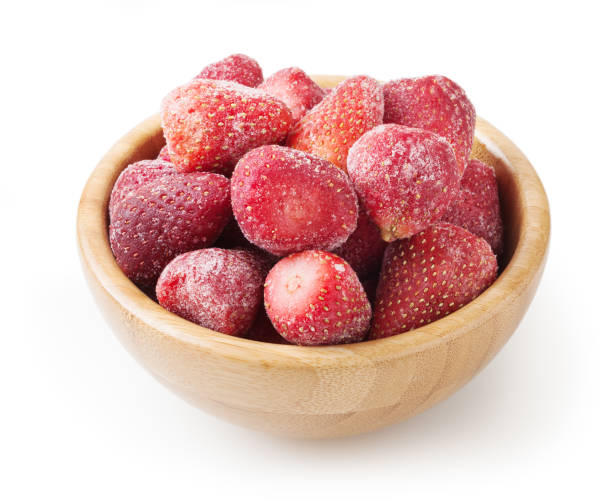 istock Frozen strawberries in wooden bowl isolated on white background 1161175408