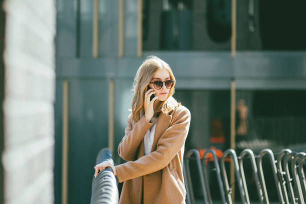istock Young woman calling with smart phone 1161176408